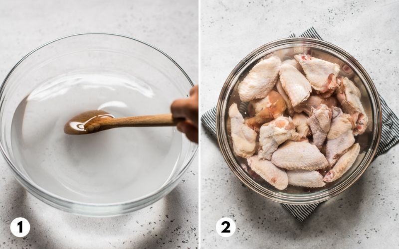 Chicken wings in a large bowl filled with brining liquid made from water, salt and sugar.