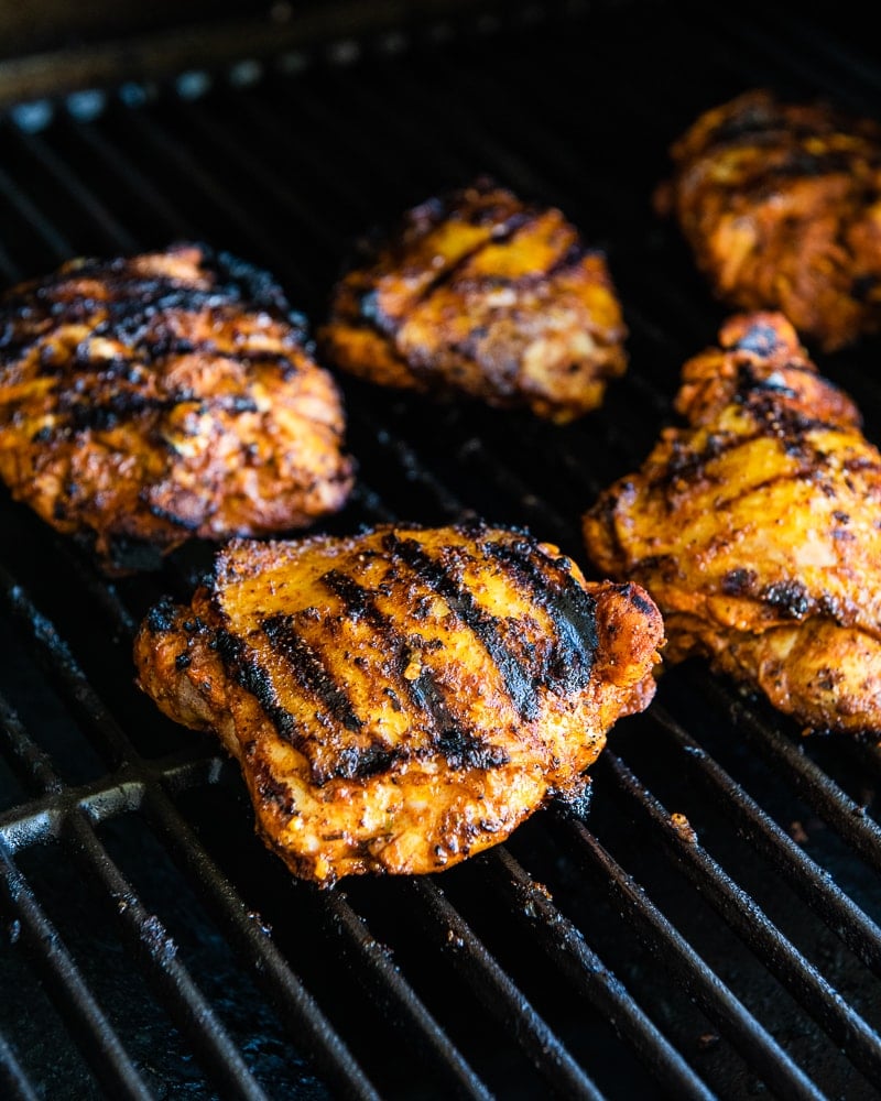 Pollo Asado chicken thighs (Mexican grilled chicken) on a grill ready to serve.