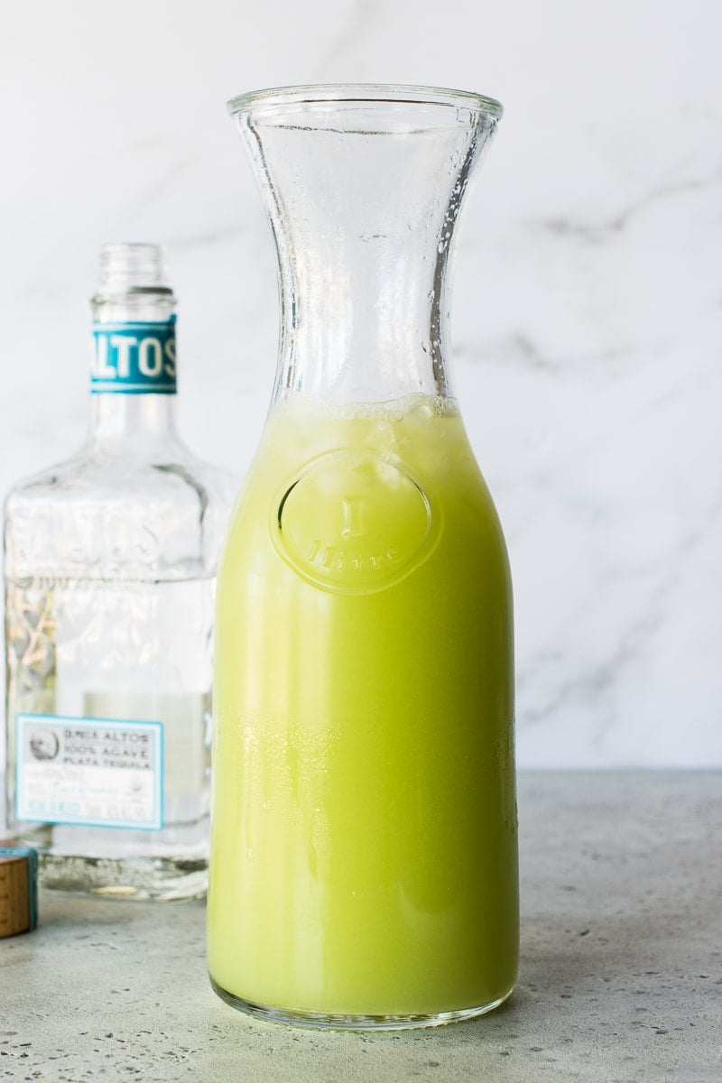 A glass pitcher of cucumber margaritas.