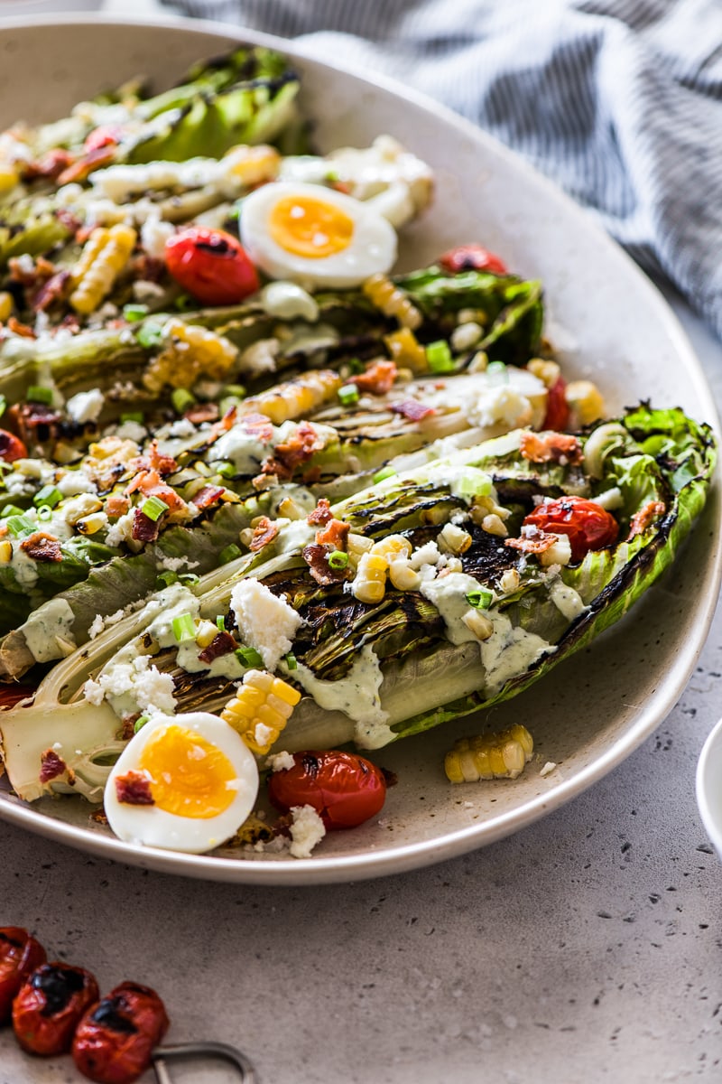 Grilled Romaine salad topped with cotija cheese, corn, tomatoes, hardboiled eggs and jalapeno ranch.