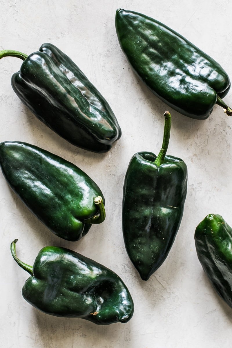 Raw poblano peppers on a table. 