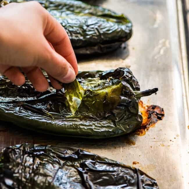 Pulling the skin off of roasted poblano peppers