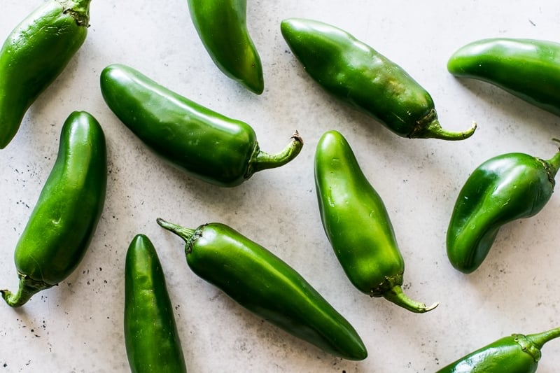 Jalapeno peppers on a gray table.