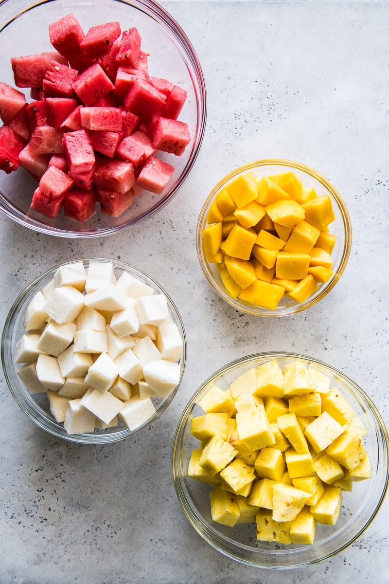 Cut fruit in bowls for Mexican fruit cups. Includes watermelon, mango, jicama and pineapple.