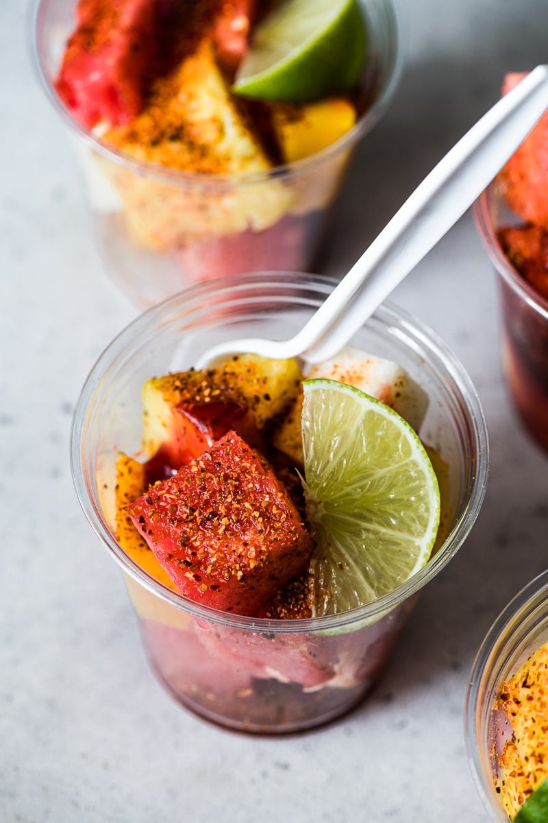 Watermelon in a Mexican fruit cup topped with chile lime tajin seasoning, lime juice and chamoy sauce.