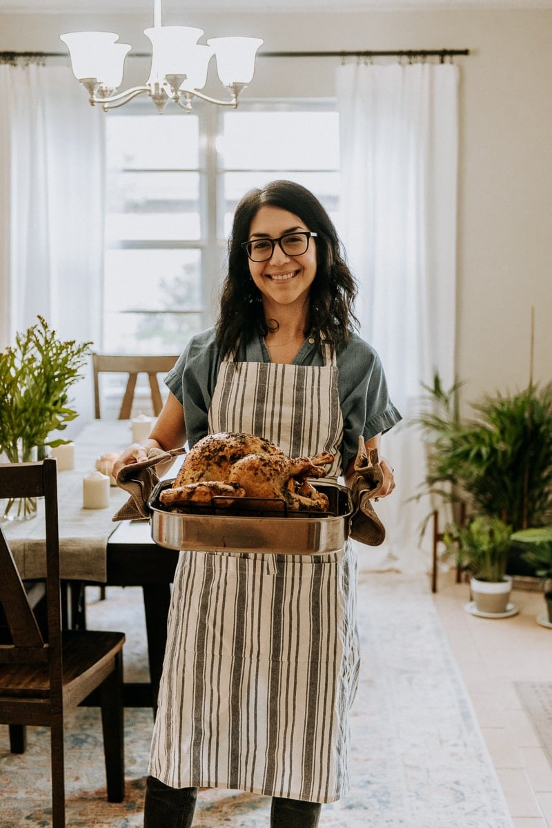 Isabel Orozco-Moore of Isabel Eats holding a turkey for Friendsgiving.