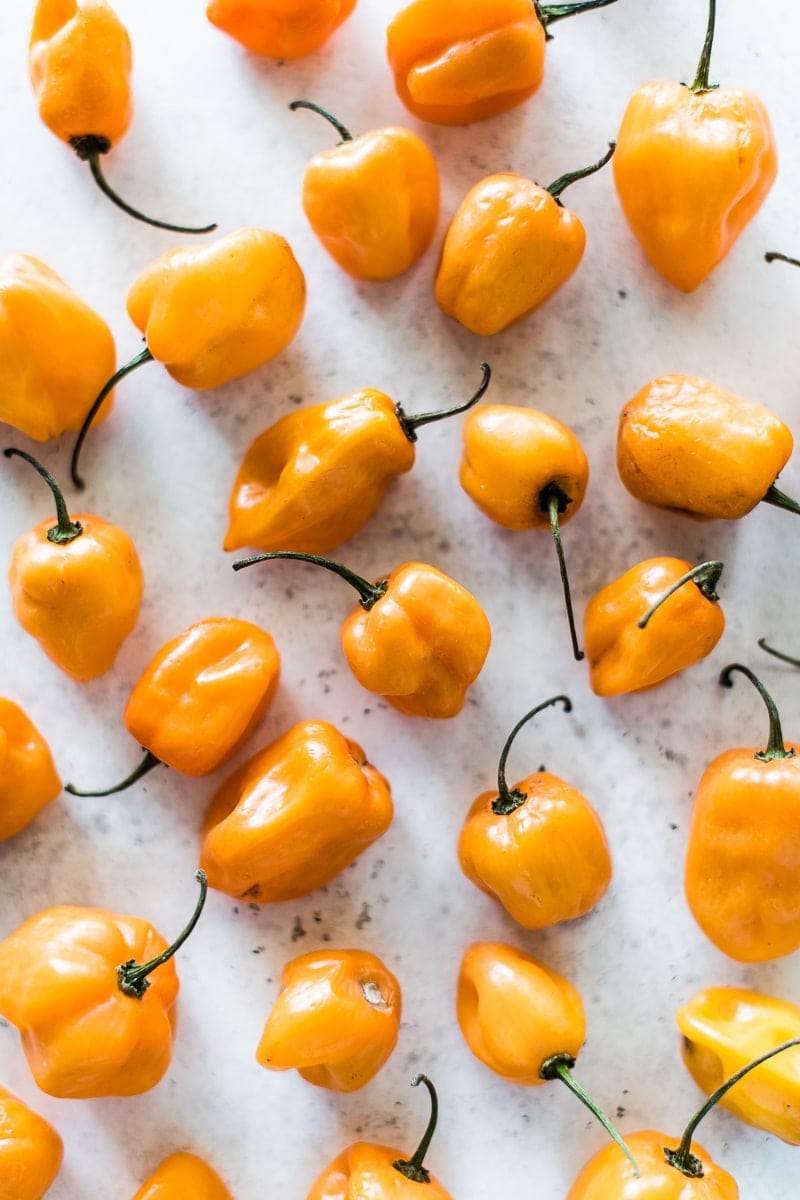 Habanero peppers spread out on a table.