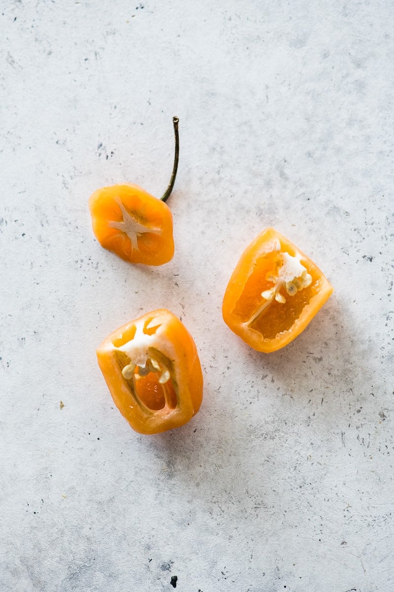 A habanero pepper sliced open to see the veins and seeds.