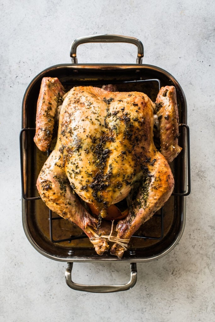 A roast turkey with crispy golden skin ready to be eaten.