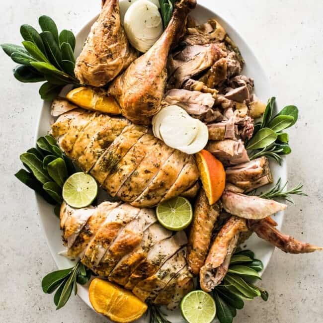A carved turkey on a large white platter.