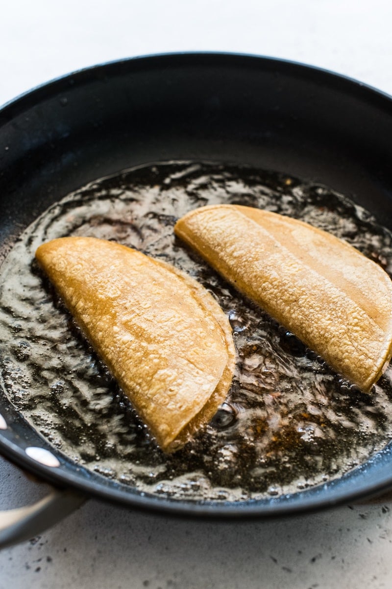 Potato Tacos (Tacos de Papa) frying in a large skillet.