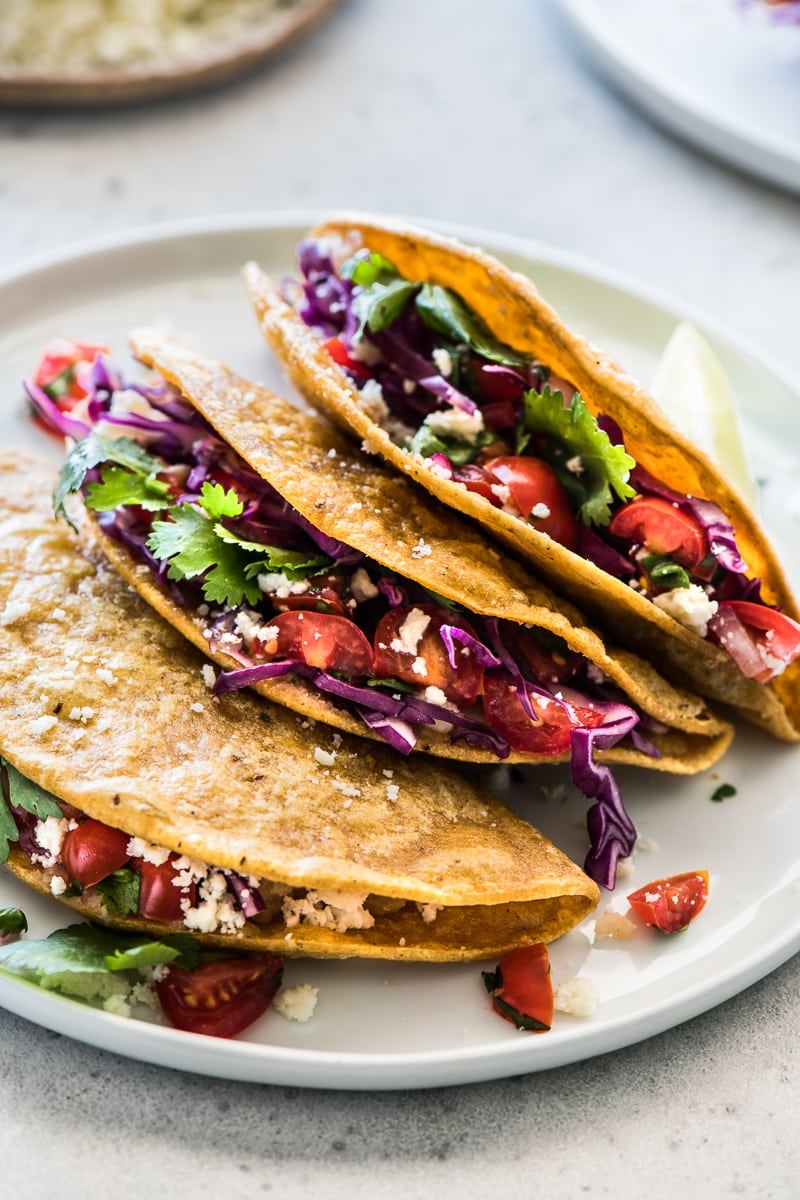 Crispy Potato Tacos filled with shredded cabbage, pico de gallo and cotija cheese.