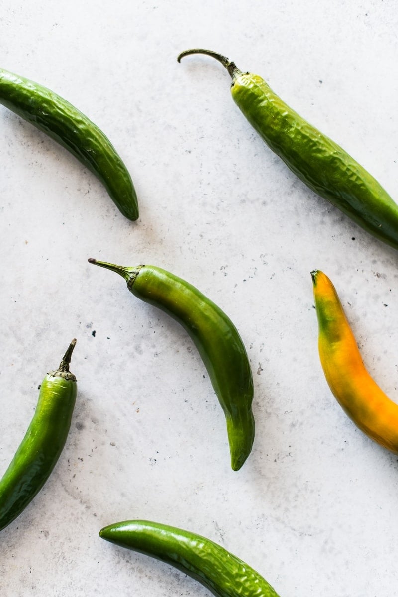 Serrano peppers on a white table.