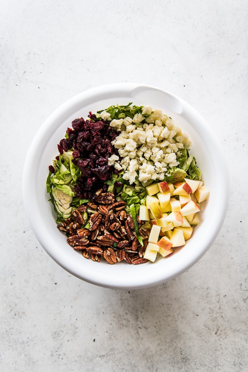 Ingredients for brussels sprout salad in a bowl.