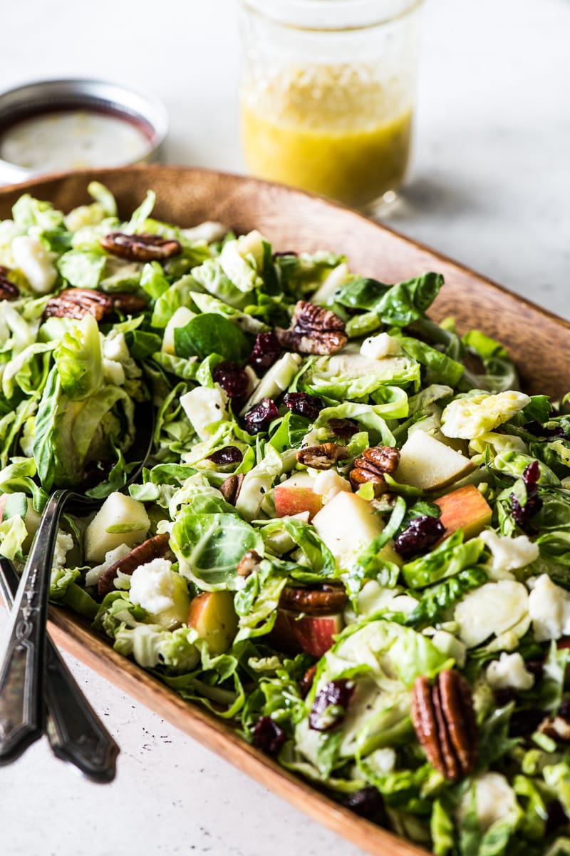 Brussels sprouts, apples, pecan and dried cranberries on a serving dish.