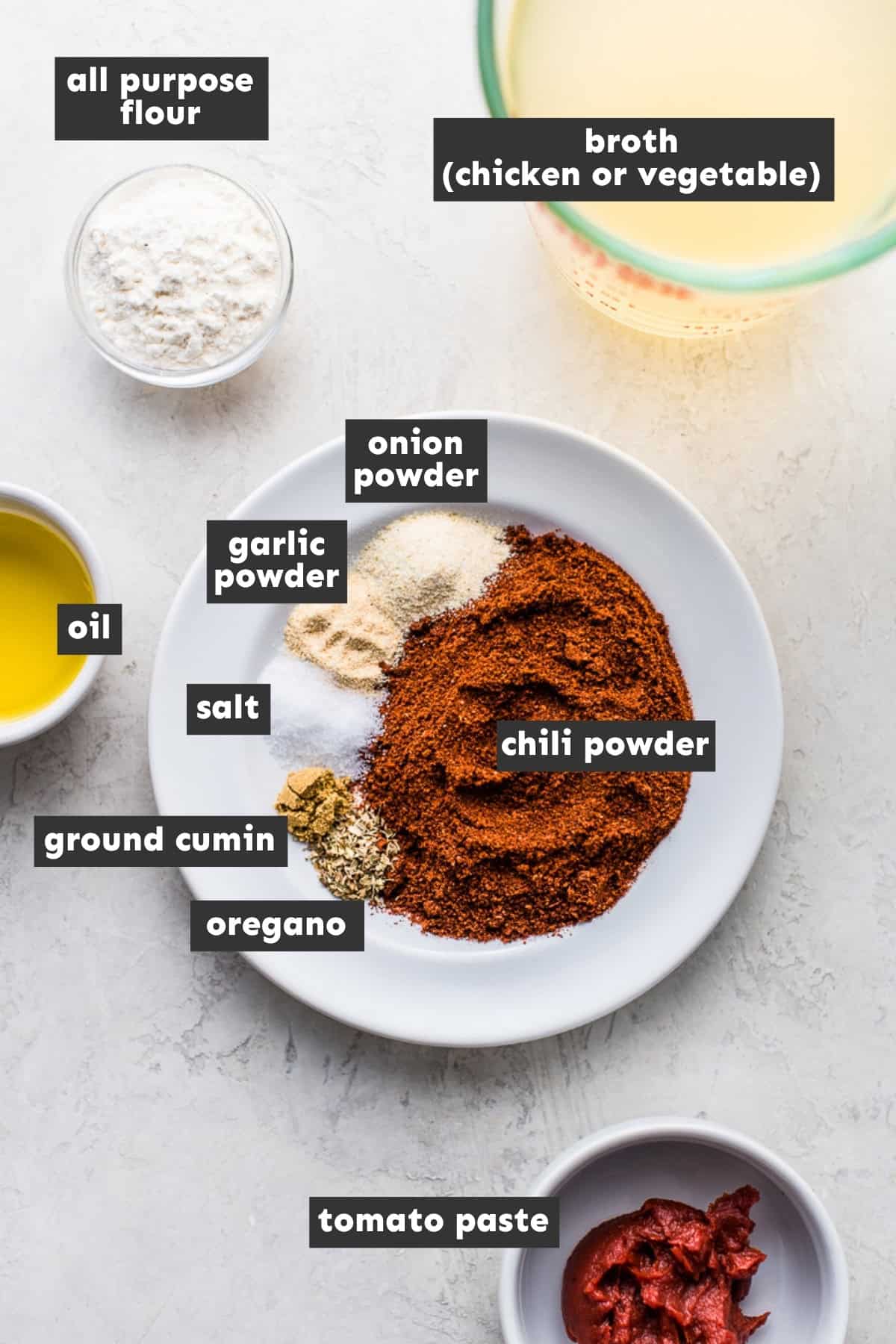 Ingredients for an easy enchilada sauce recipe including chili powder, tomato paste and broth.