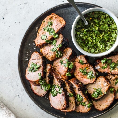This Grilled Pork Tenderloin is an all-time grilling favorite! Rubbed with a blend of smoky spices like chipotle powder, ground cumin and smoked paprika, this recipe makes unbelievably juicy pork every single time. #porkrecipes #grillingrecipes #porktenderloin
