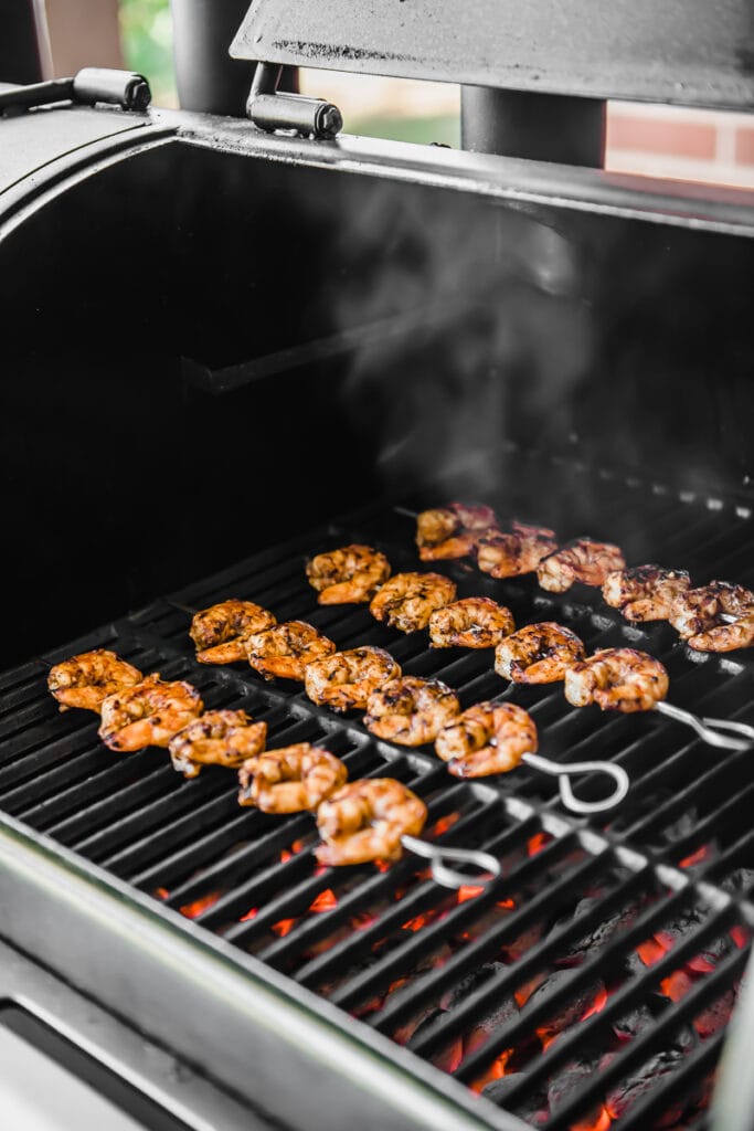 Shrimp skewers on a charcoal grill for shrimp tacos.