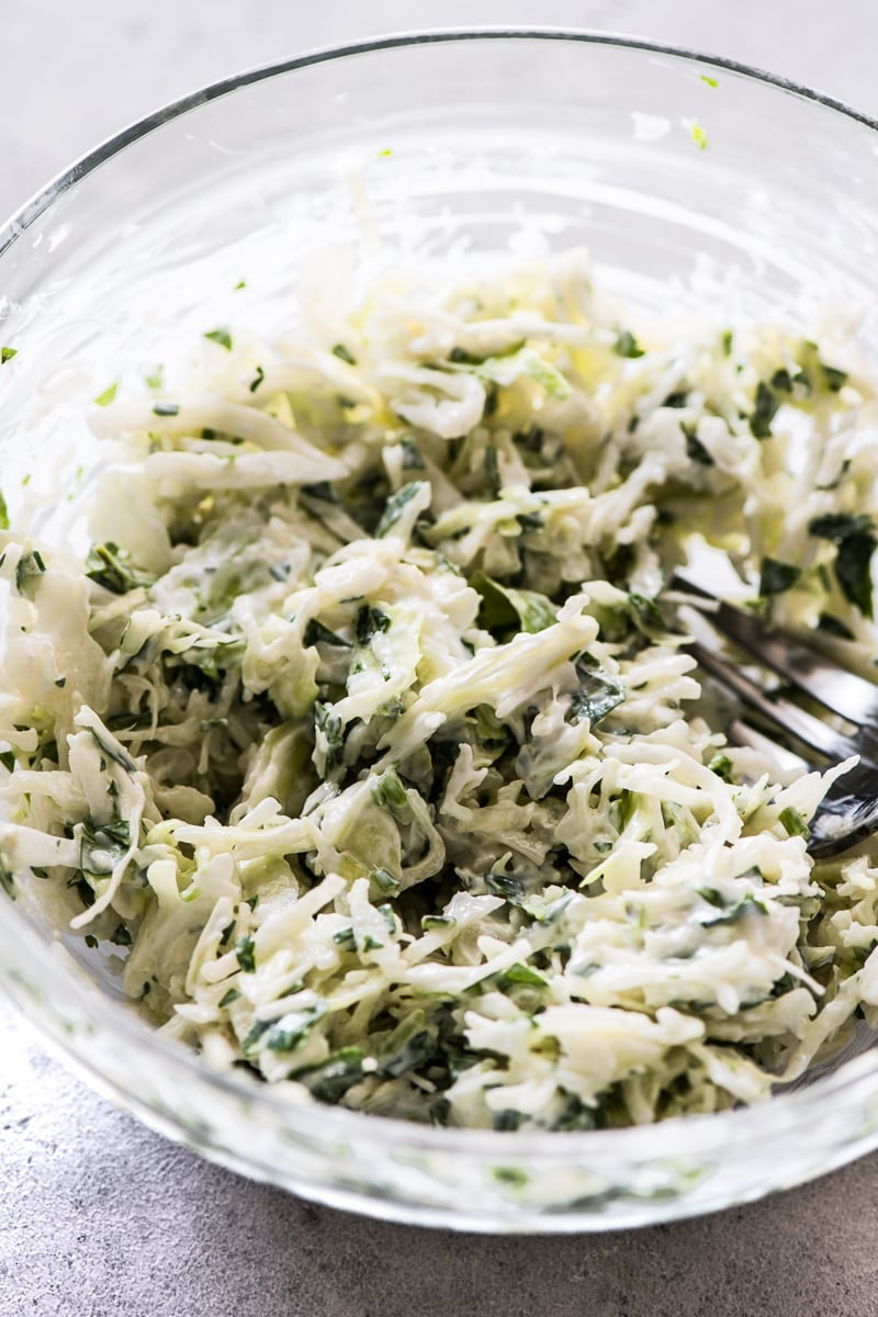 A bowl of creamy slaw for topping on grilled shrimp tacos.