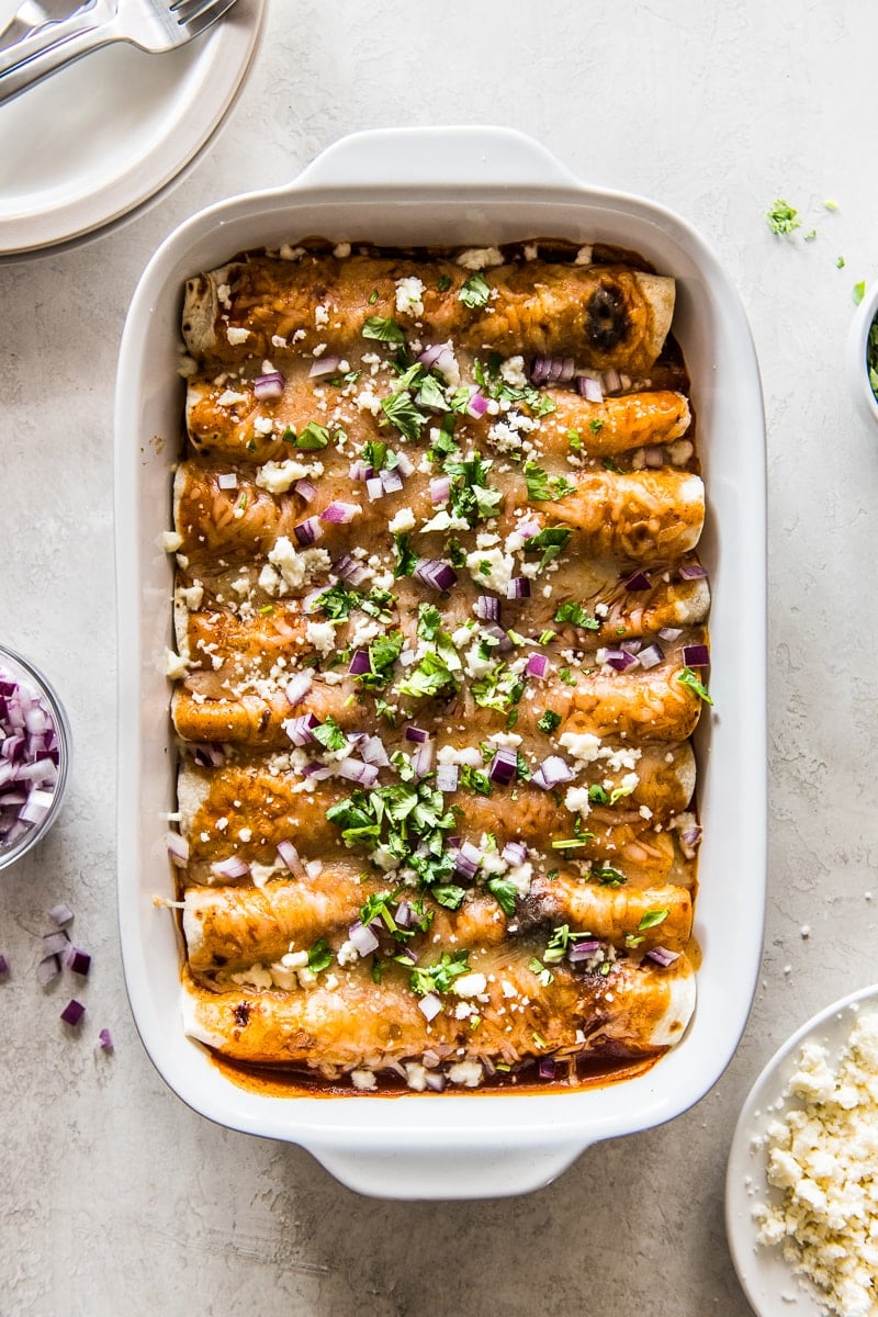Breakfast Enchiladas topped with cilantro and red onions.