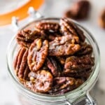 These candied pecans are easy to make on the stovetop - no need to turn on the oven! Crunchy, sweet and the perfect little snack, they're ready in under 10 minutes. Perfect for topping on salads and dessert, they even make a great holiday gift! #candiedpecans #holidays #pecans