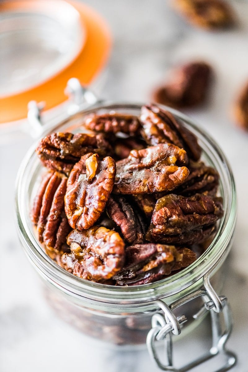 These candied pecans are easy to make on the stovetop - no need to turn on the oven! Crunchy, sweet and the perfect little snack, they're ready in under 10 minutes. Perfect for topping on salads and dessert, they even make a great holiday gift! #candiedpecans #holidays #pecans