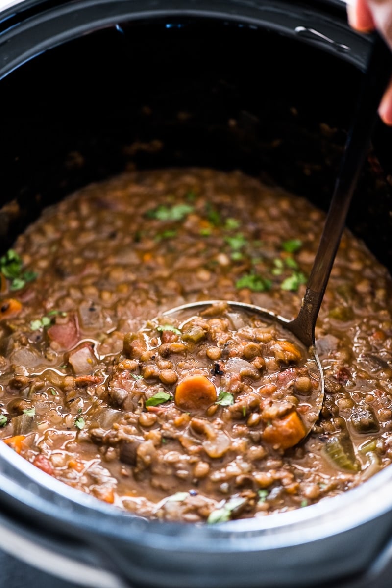 A ladle full of crockpot lentil soup