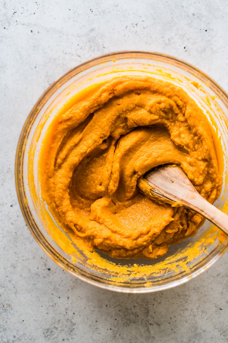 Mixing bowl filled with mashed sweet potatoes.