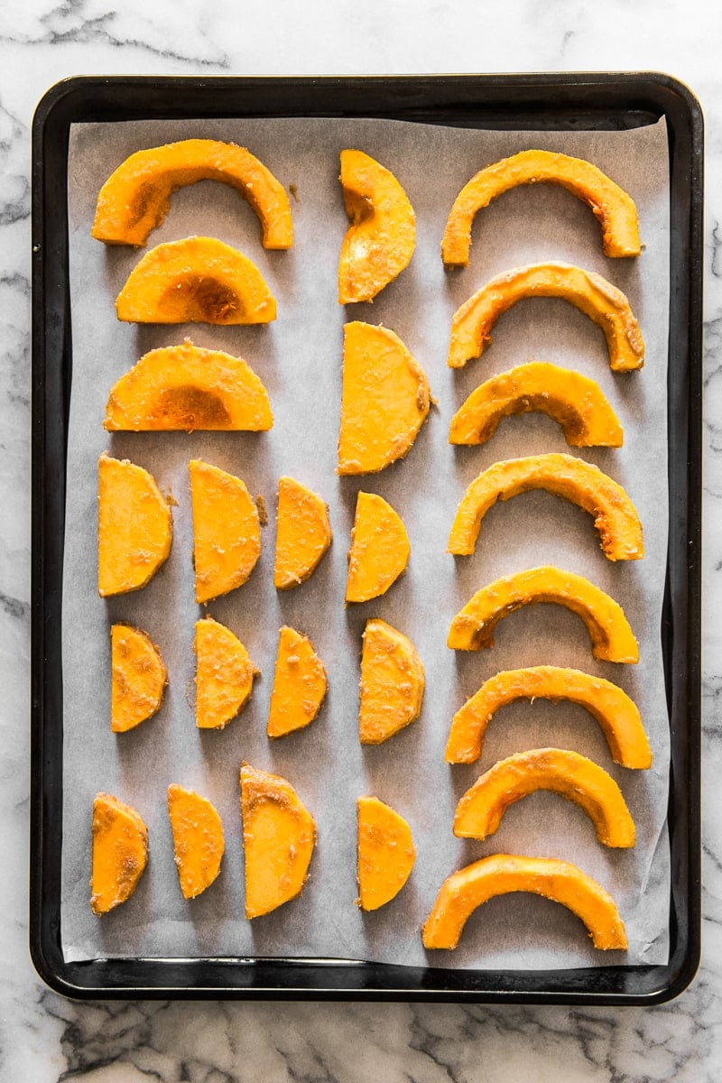 Cut butternut squash on a baking sheet lined with parchment paper.
