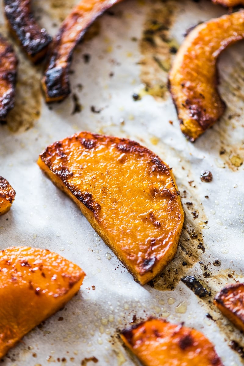 Roasted butternut squash on parchment paper.