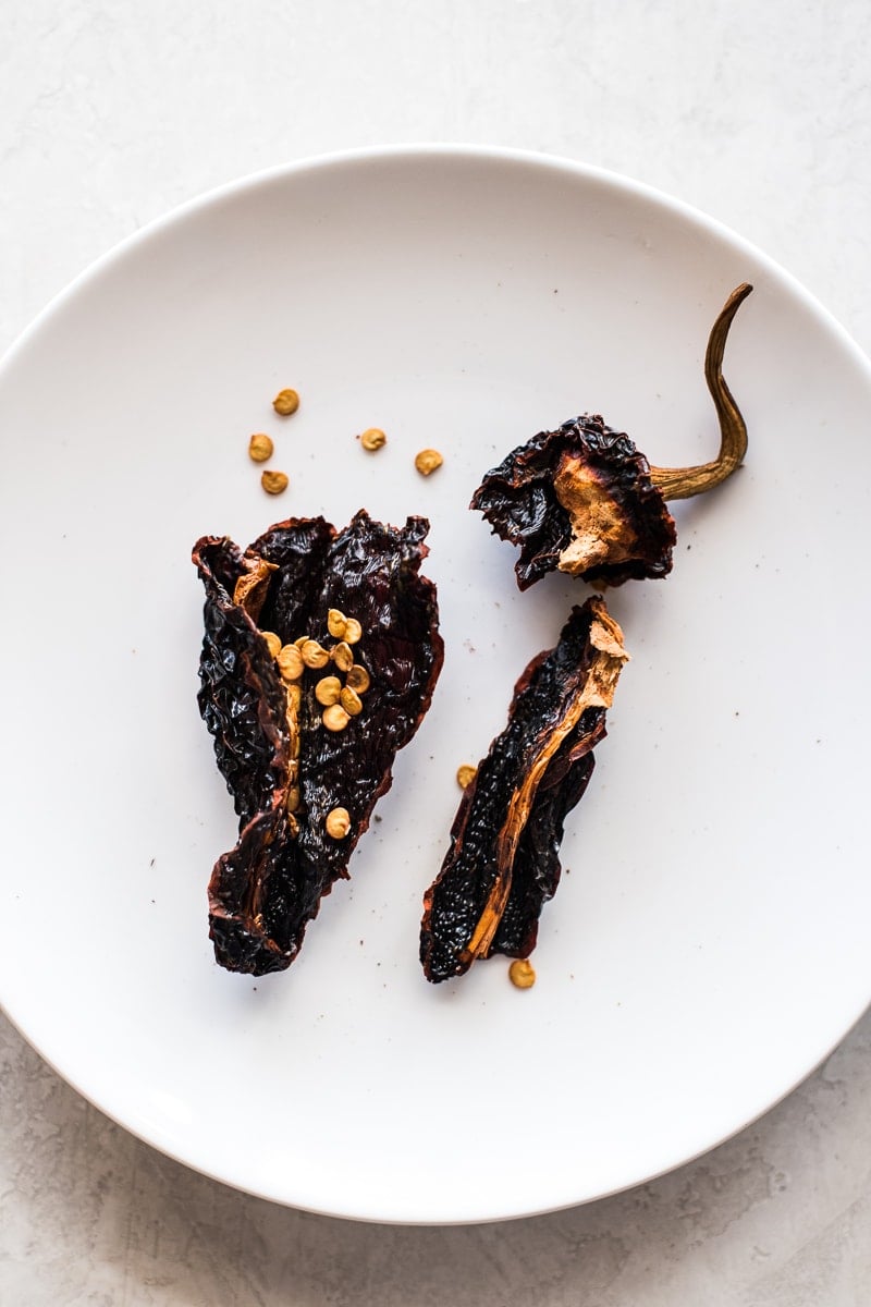 Ancho chiles cut open with seeds and veins exposed