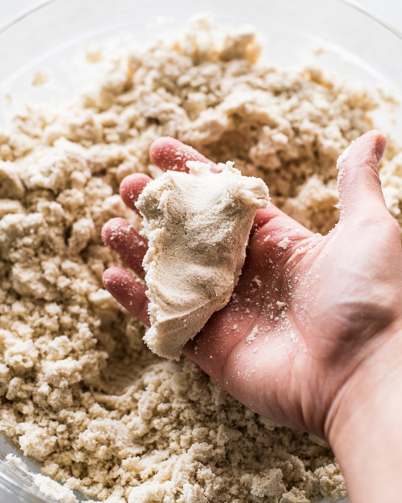 A hand holding some masa for tamales