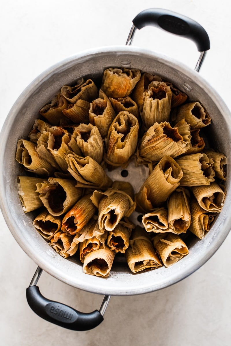 Pork tamales in a steamer pot ready to be steamed.