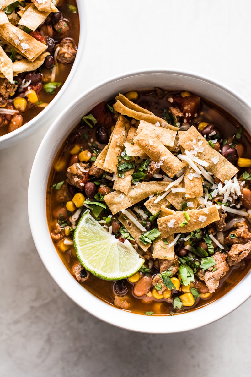 Slow cooker taco soup topped with tortilla strips