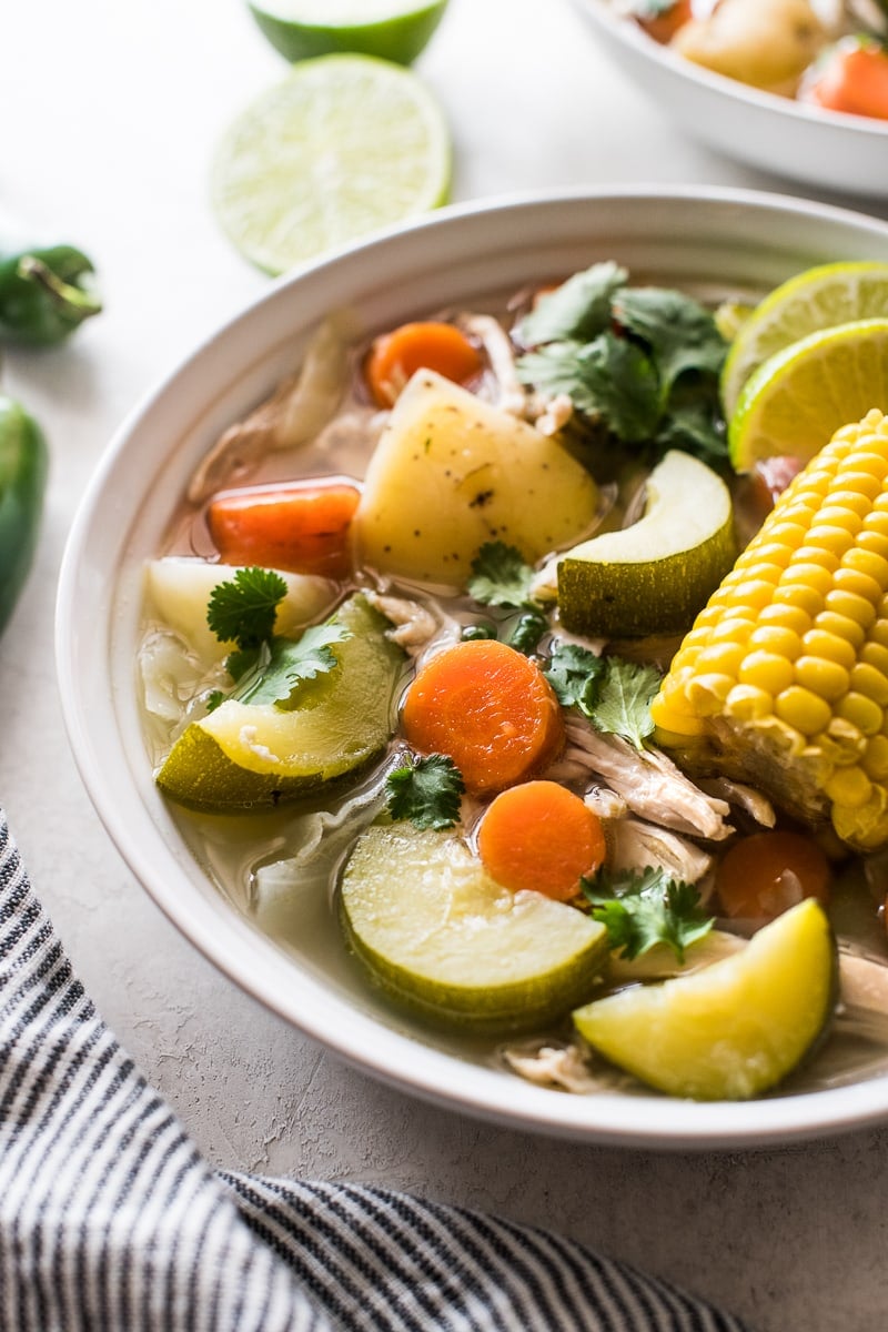 Vegetables like squash, carrots and corn in caldo de pollo