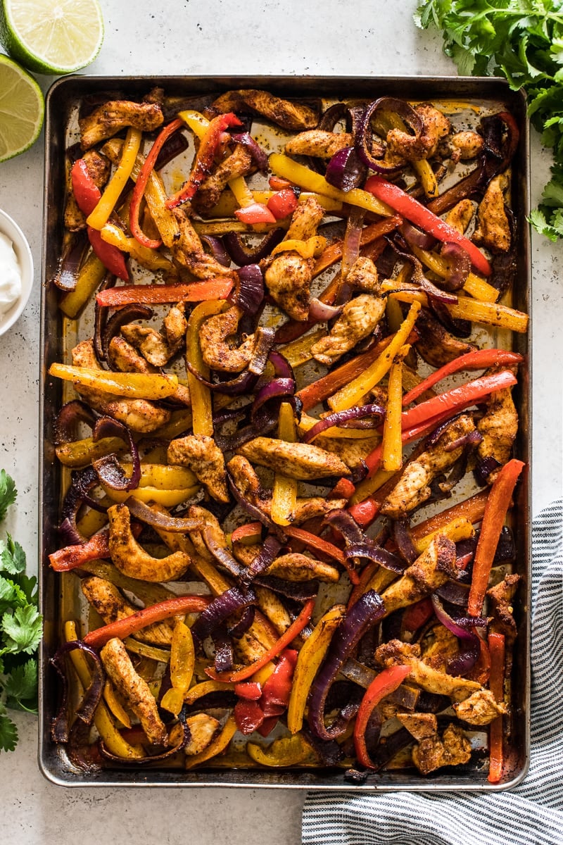 Sheet pan chicken fajitas on a sheet pan ready to serve.