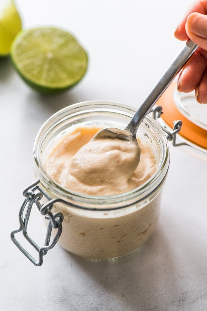 Fish taco sauce in a jar with a spoon