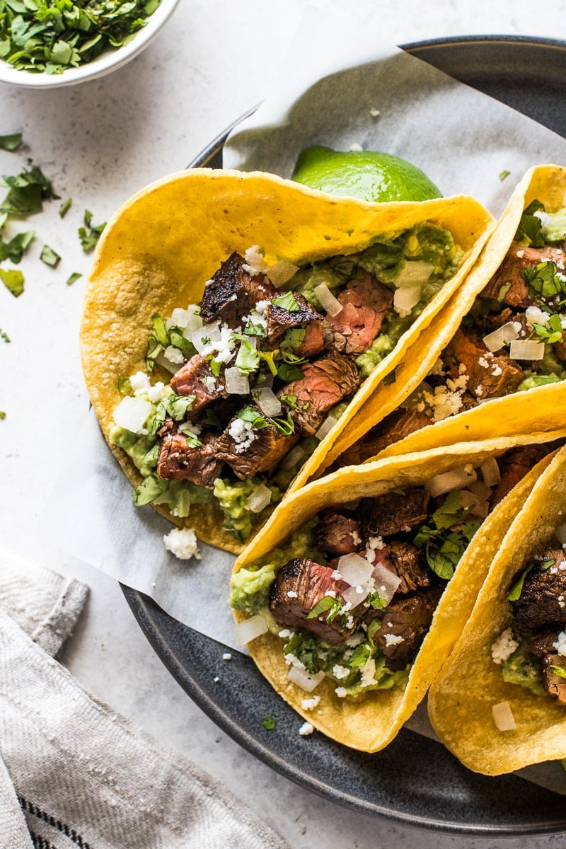 Carne Asada Tacos topped with cotija cheese, onions and cilantro.