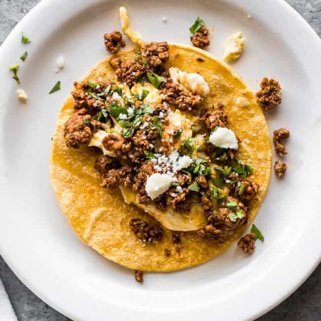 A taco filled with chorizo and scrambled eggs.