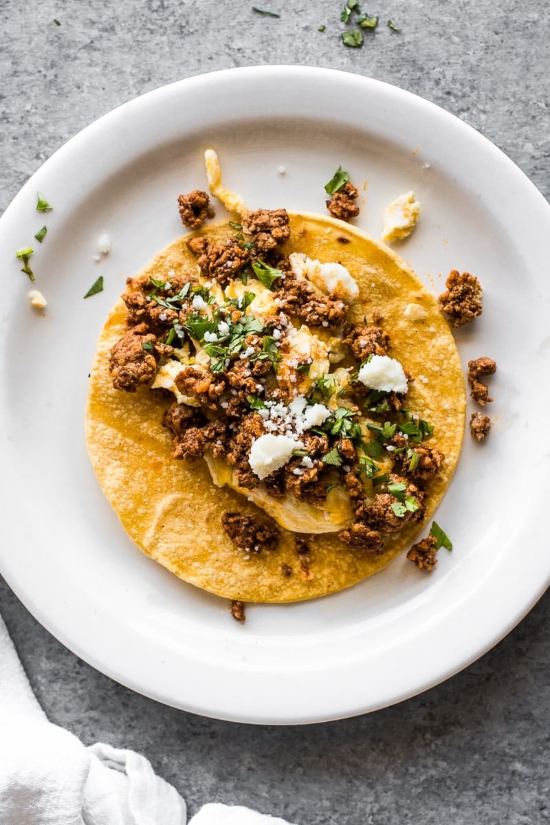 A taco filled with chorizo and scrambled eggs.