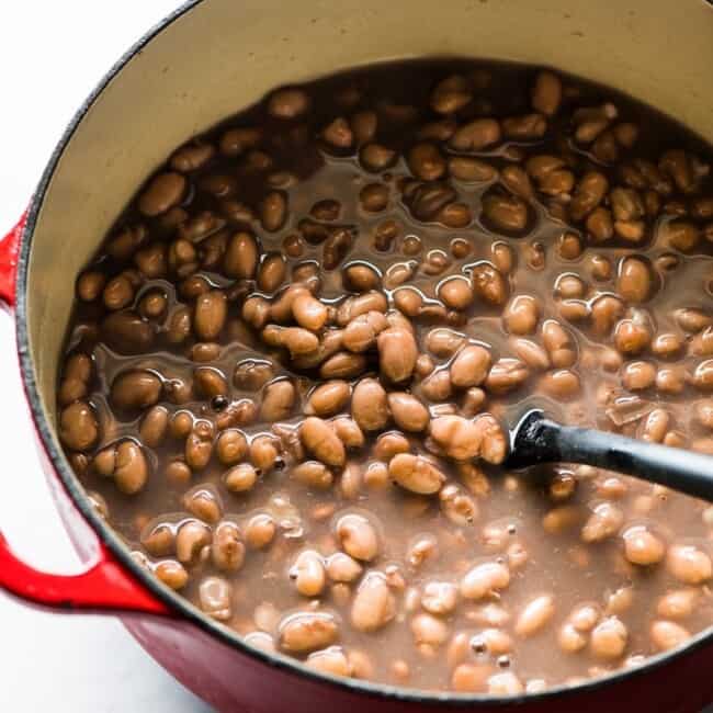 Cooked pinto beans in a pot.