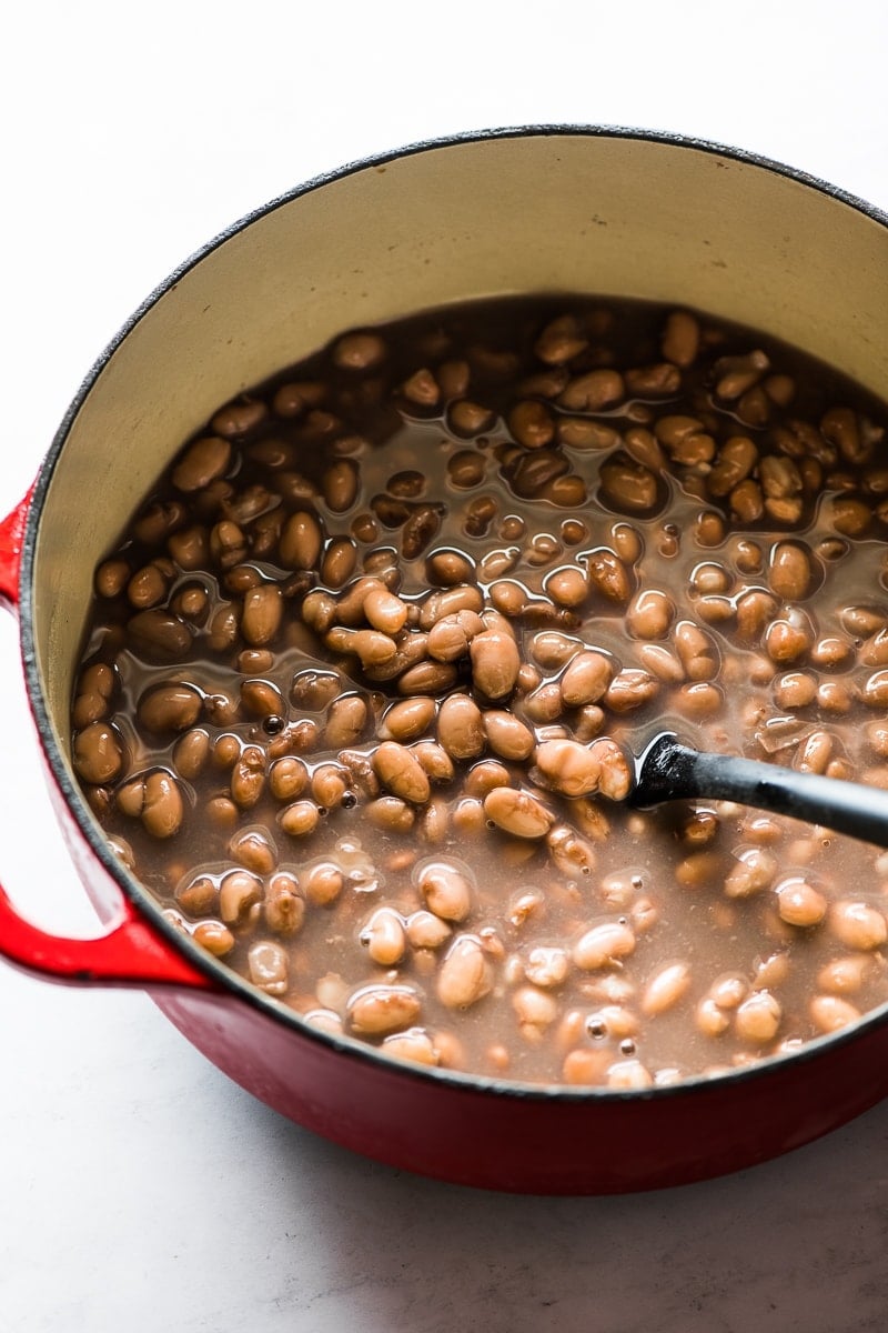 Cooked pinto beans in a pot.