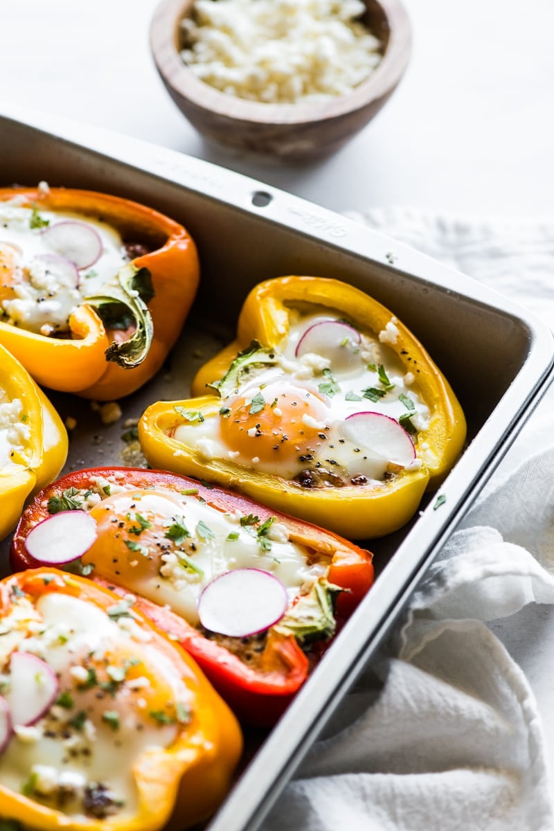 Breakfast Stuffed Peppers topped with cheese, cilantro and radishes