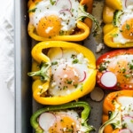 Breakfast stuffed peppers in a baking pan.