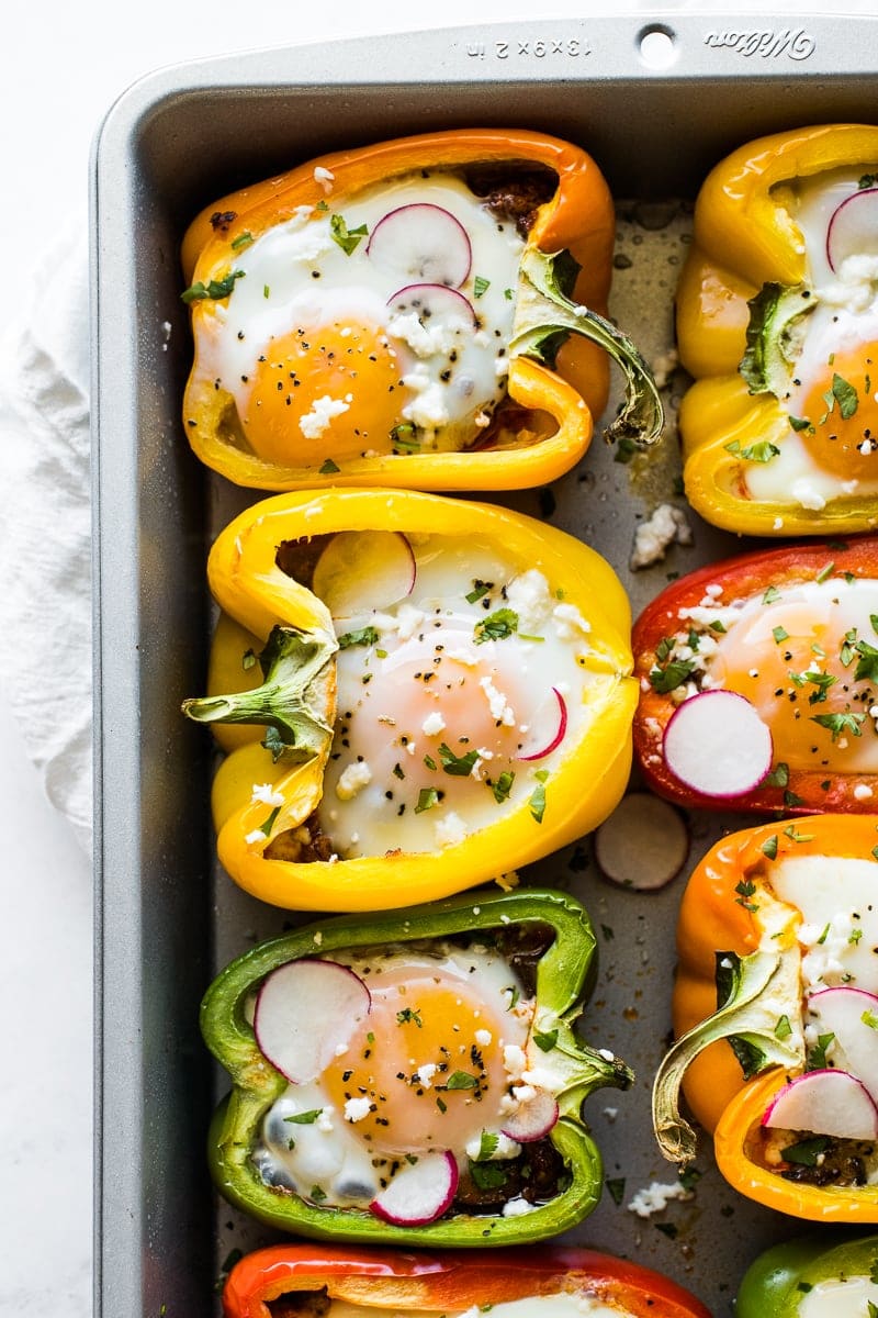 Breakfast stuffed peppers in a baking pan.