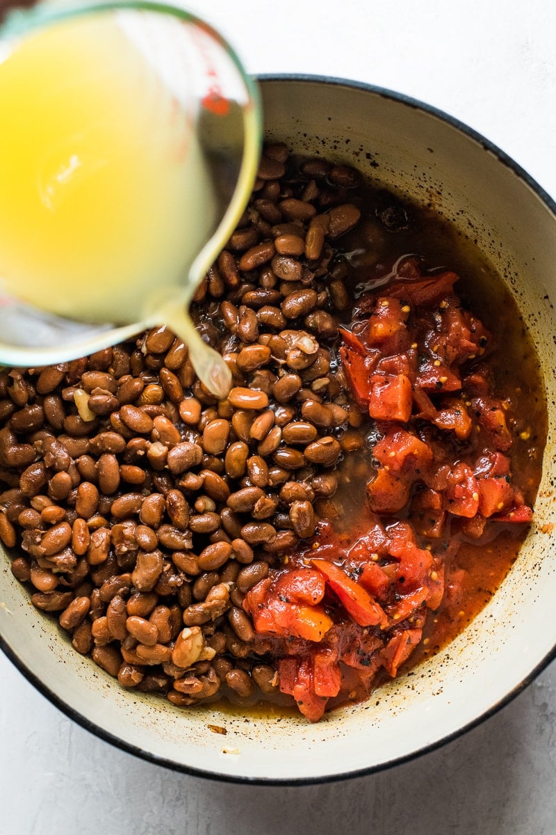 Pinto beans and diced tomatoes in a pot