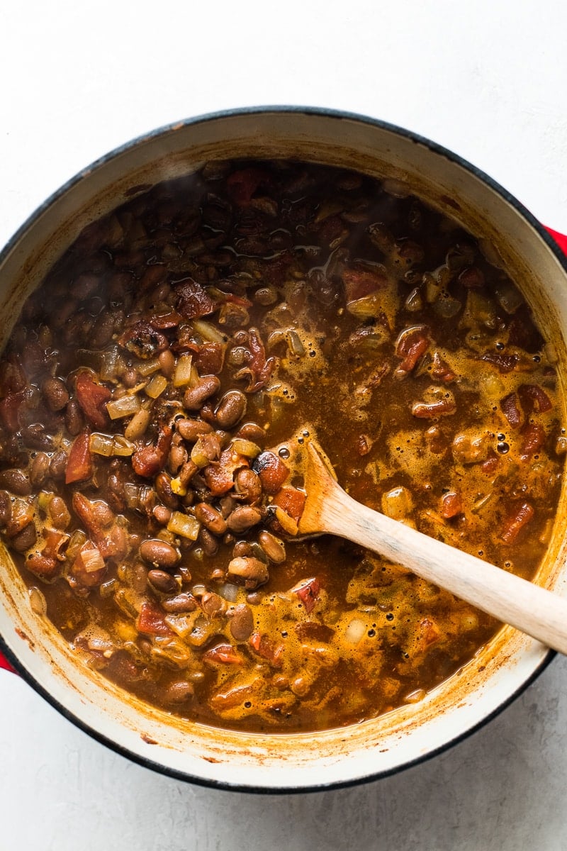 Stirring pinto bean soup in a pot