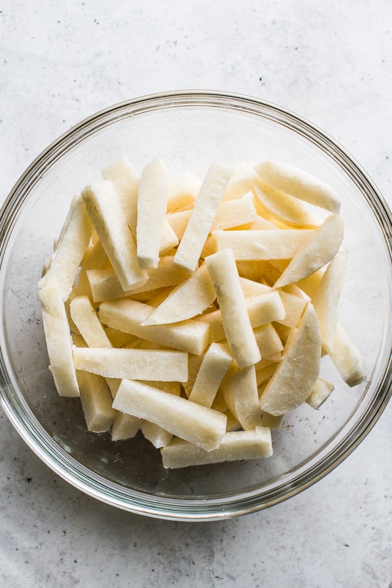 Sliced raw jicama in a bowl.