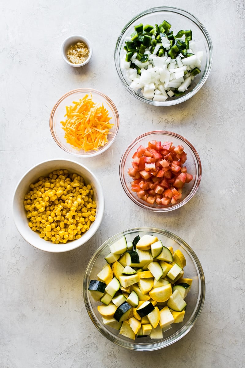 Ingredients to make calabacitas on a table.