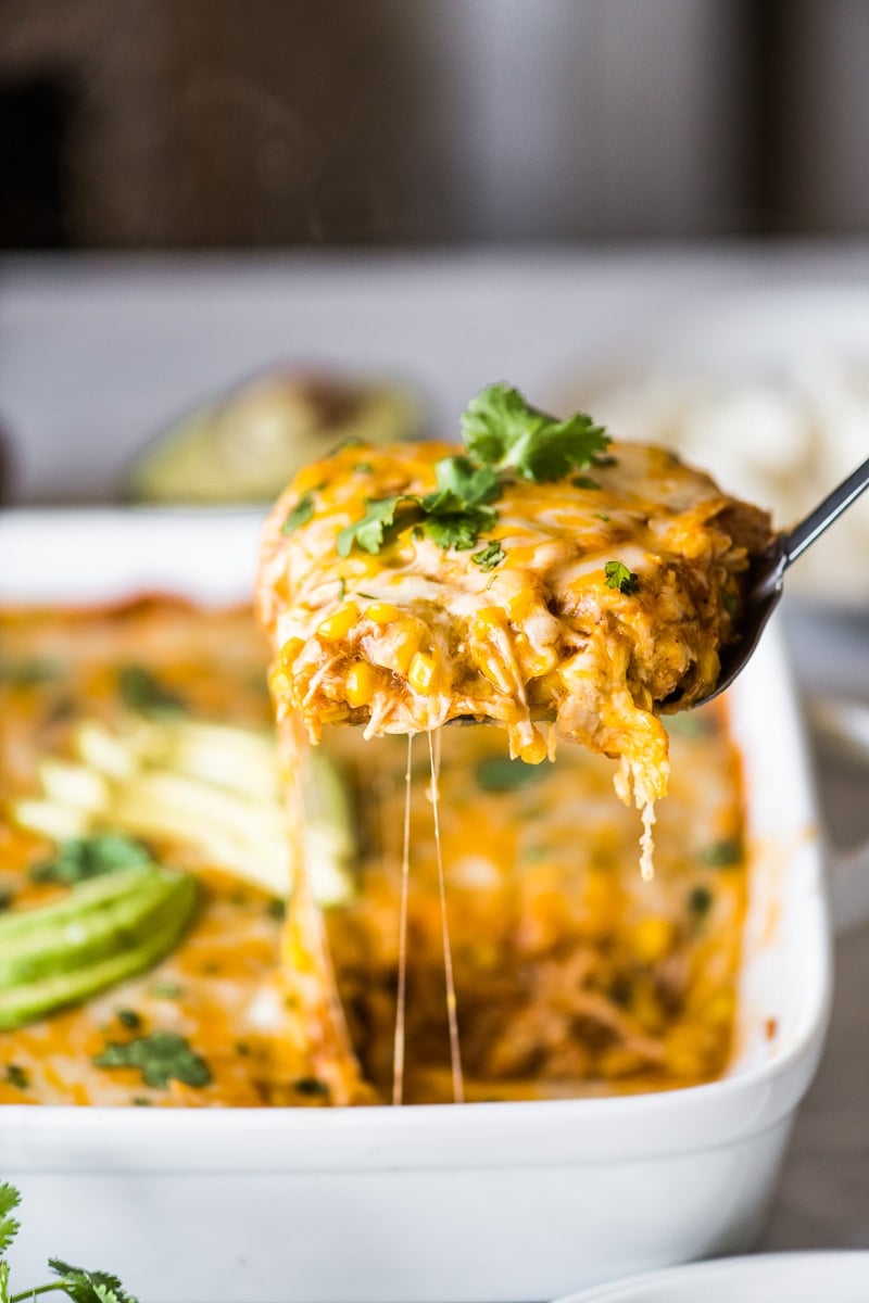 A spatula holding a slice of chicken tamale casserole.